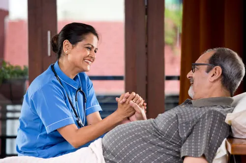 A nurse from Adarsh Nursing Bureau attending to a patient at home